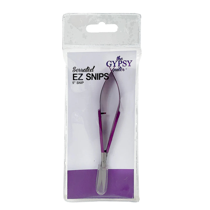Serrated EZ Snips 5" snap in purple and silver, packaged in a clear plastic sleeve with a white backing card. The packaging features the brand name &